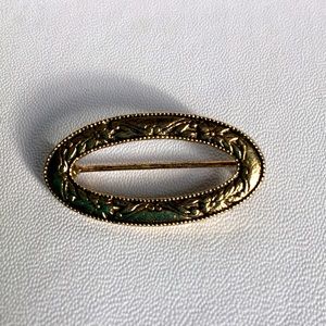 Vintage elliptical floral metal brooch